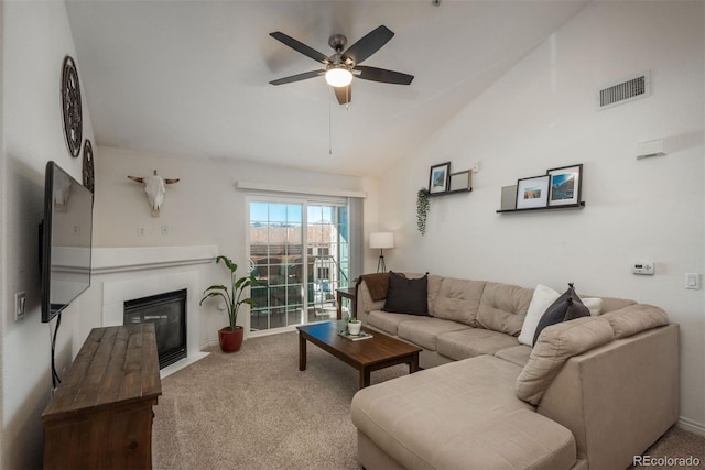 living room with ceiling fan, a fireplace, carpet, and lofted ceiling