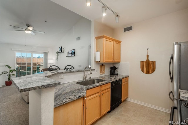 kitchen featuring sink, lofted ceiling, kitchen peninsula, dishwasher, and stainless steel fridge