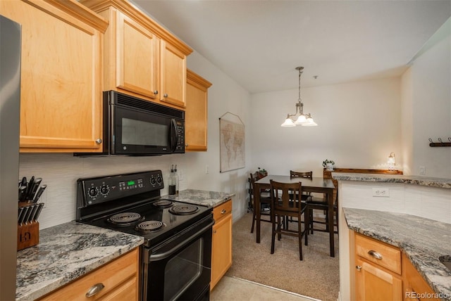 kitchen with light brown cabinets, hanging light fixtures, black appliances, an inviting chandelier, and light stone counters