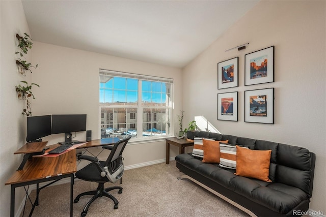 carpeted office with lofted ceiling