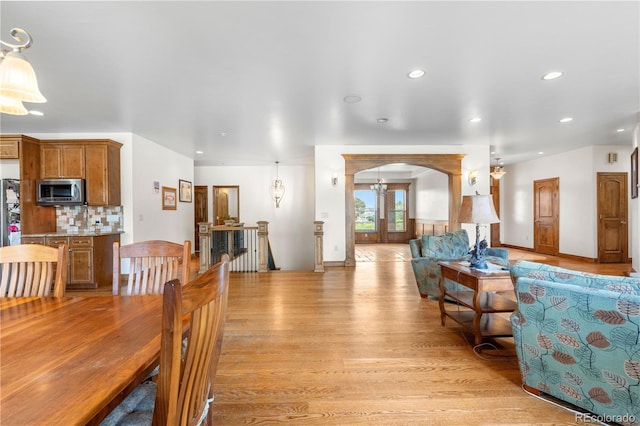 1195 W 70th Ave, Denver, CO 80221 - dining room with light wood finished floors, arched walkways, and recessed lighting