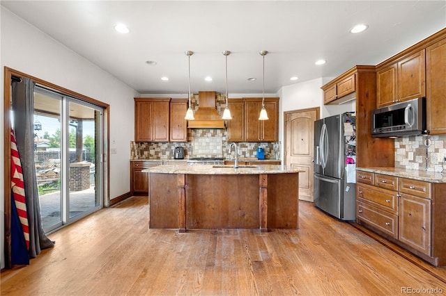1195 W 70th Ave, Denver, CO 80221 - kitchen featuring appliances with stainless steel finishes, custom exhaust hood, light wood-style flooring, recessed lighting, and decorative backsplash