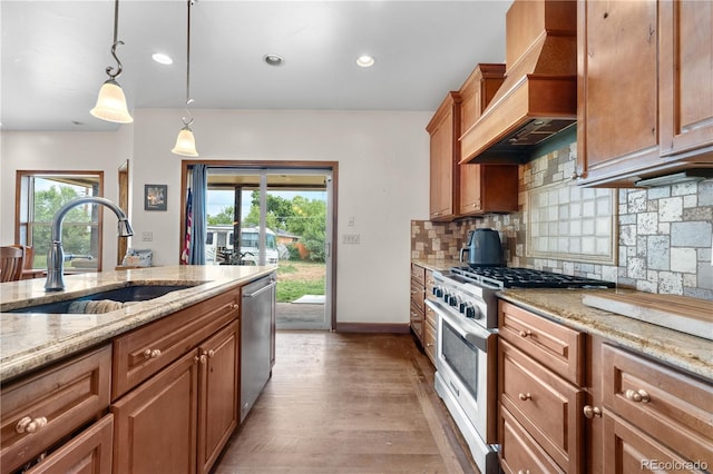 1195 W 70th Ave, Denver, CO 80221 - kitchen featuring premium range hood, stainless steel appliances, plenty of natural light, light wood-type flooring, and recessed lighting