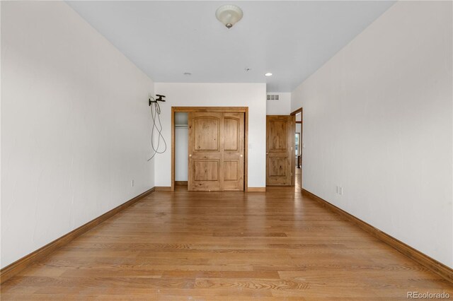 1195 W 70th Ave, Denver, CO 80221 - unfurnished bedroom with light wood finished floors and recessed lighting