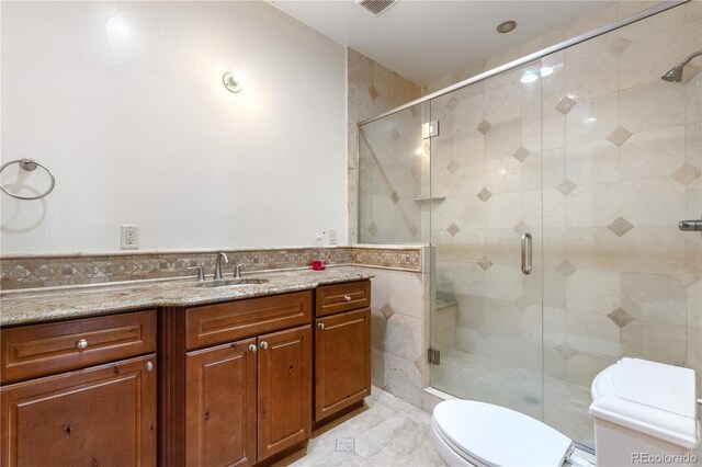1195 W 70th Ave, Denver, CO 80221 - full bathroom featuring vanity, a shower stall, and tile walls