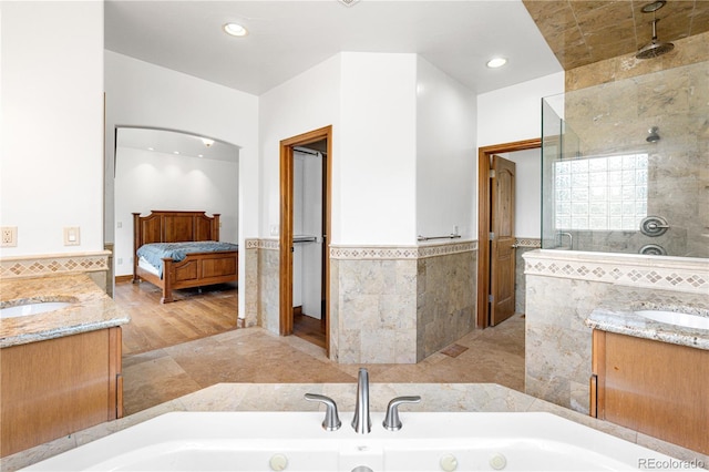 1195 W 70th Ave, Denver, CO 80221 - ensuite bathroom with tile walls, a whirlpool tub, vanity, wainscoting, and walk in shower