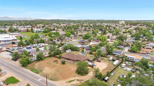 1195 W 70th Ave, Denver, CO 80221 - aerial overview of property's location with a mountain backdrop and nearby suburban area
