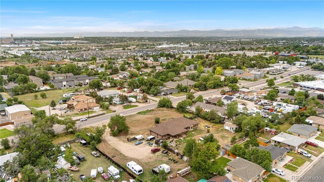 1195 W 70th Ave, Denver, CO 80221 - aerial overview of property's location featuring a mountain backdrop and nearby suburban area