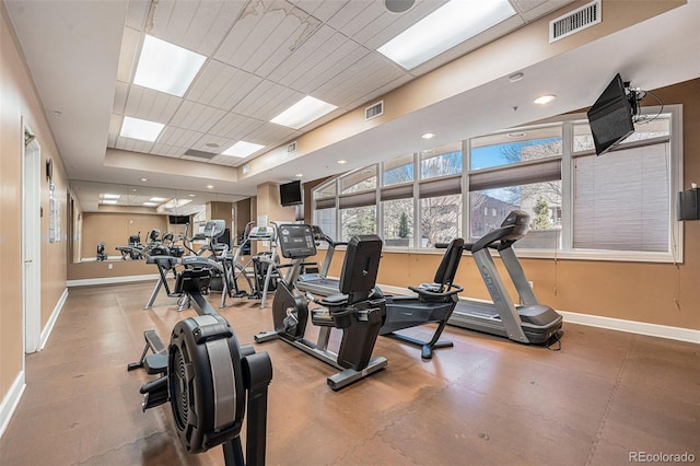 gym featuring baseboards, visible vents, and a drop ceiling