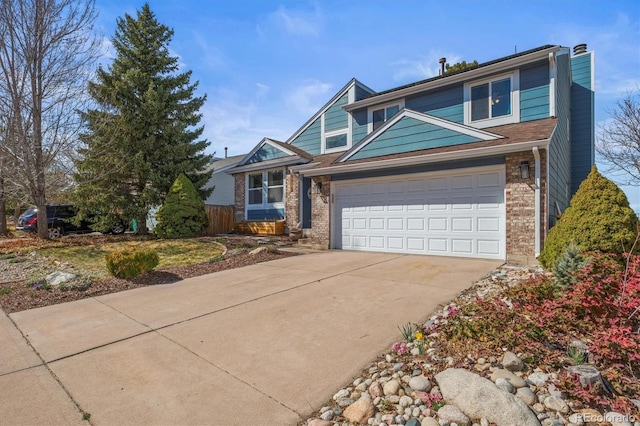 8815 W Quarto Cir, Littleton, CO 80128 - view of front of home with concrete driveway, a chimney, brick siding, and fence