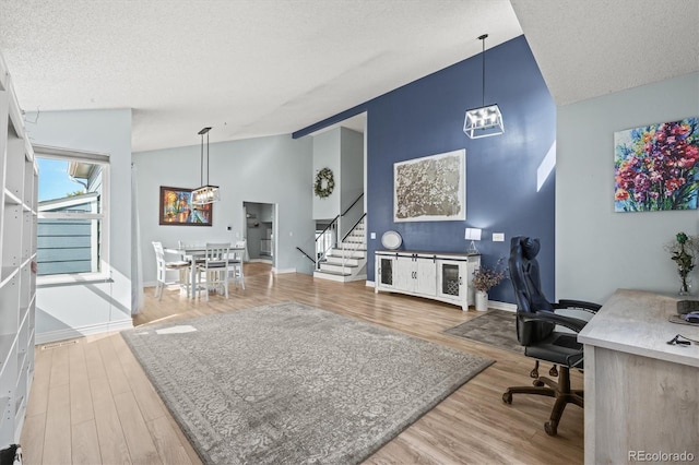 8815 W Quarto Cir, Littleton, CO 80128 - home office featuring lofted ceiling, a textured ceiling, wood finished floors, baseboards, and a chandelier