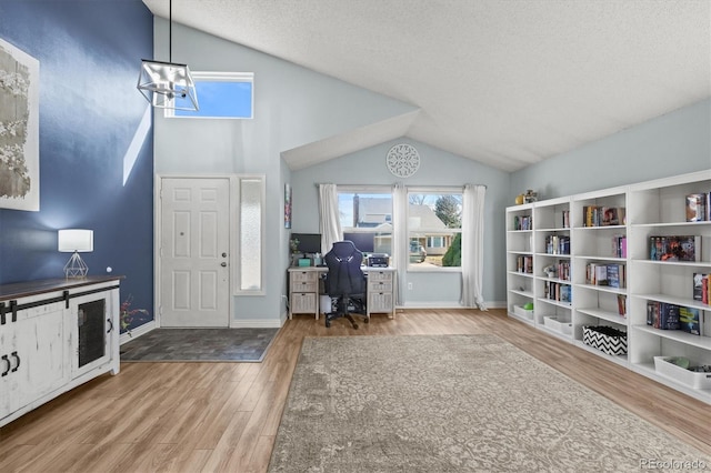 8815 W Quarto Cir, Littleton, CO 80128 - home office featuring vaulted ceiling, wood finished floors, a chandelier, a textured ceiling, and baseboards