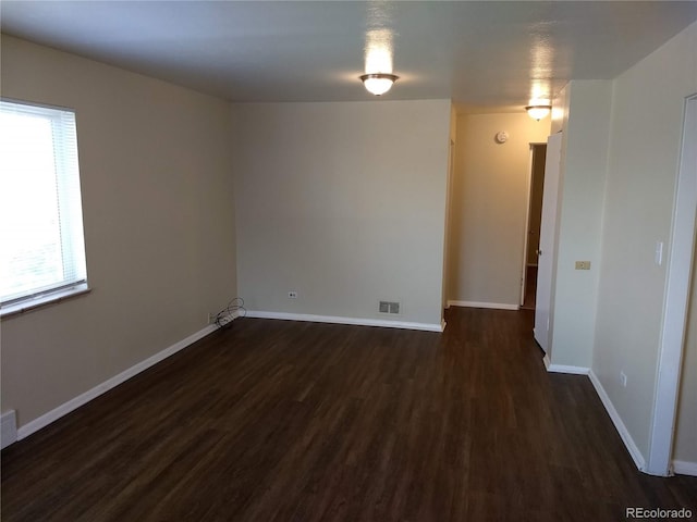 spare room featuring dark hardwood / wood-style floors