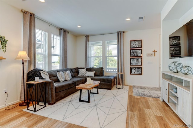 living room with a wealth of natural light and light wood-type flooring