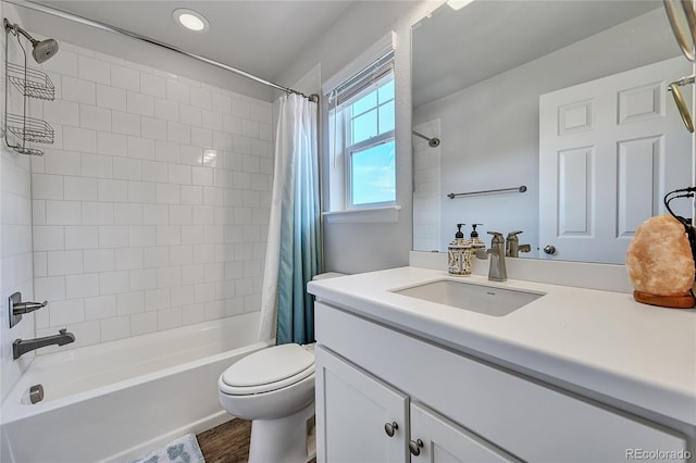 full bathroom featuring vanity, hardwood / wood-style flooring, shower / bath combo, and toilet