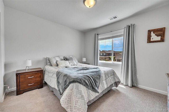 bedroom with light colored carpet