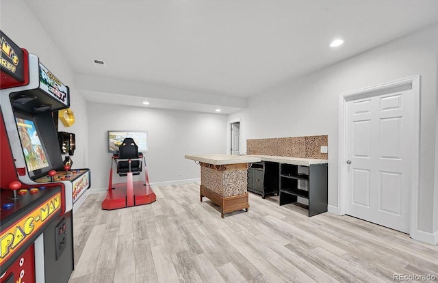 bar with light wood-type flooring