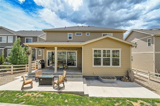 back of house featuring an outdoor fire pit and a patio