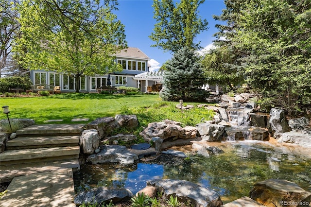 4483 W Cottonwood Pl, Littleton, CO 80123 - view of green lawn with a garden pond and a pergola