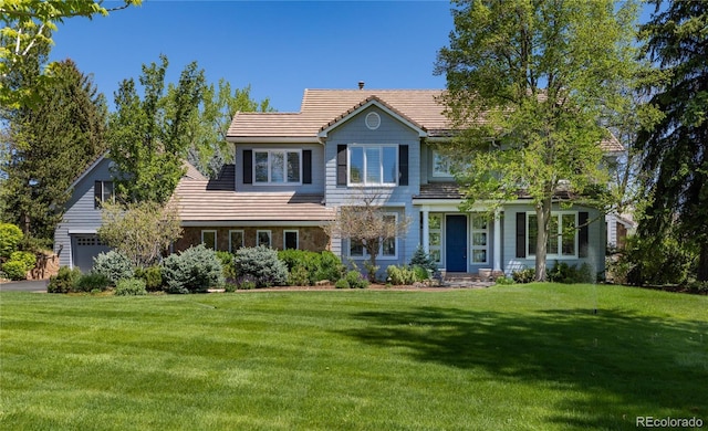 4483 W Cottonwood Pl, Littleton, CO 80123 - traditional-style house with a tiled roof, a front yard, and a garage