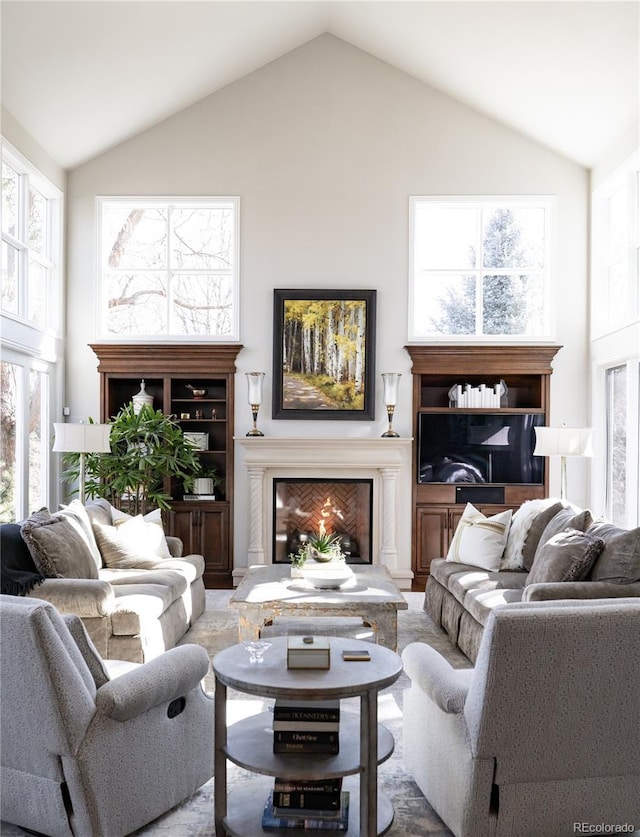 4483 W Cottonwood Pl, Littleton, CO 80123 - living room featuring high vaulted ceiling and a lit fireplace