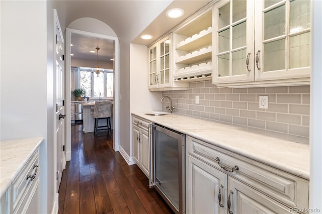 4483 W Cottonwood Pl, Littleton, CO 80123 - indoor wet bar with wine cooler, tasteful backsplash, dark wood finished floors, recessed lighting, and a chandelier