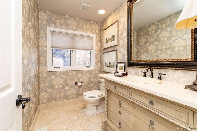 4483 W Cottonwood Pl, Littleton, CO 80123 - bathroom with toilet, tile patterned flooring, vanity, baseboards, and wallpapered walls