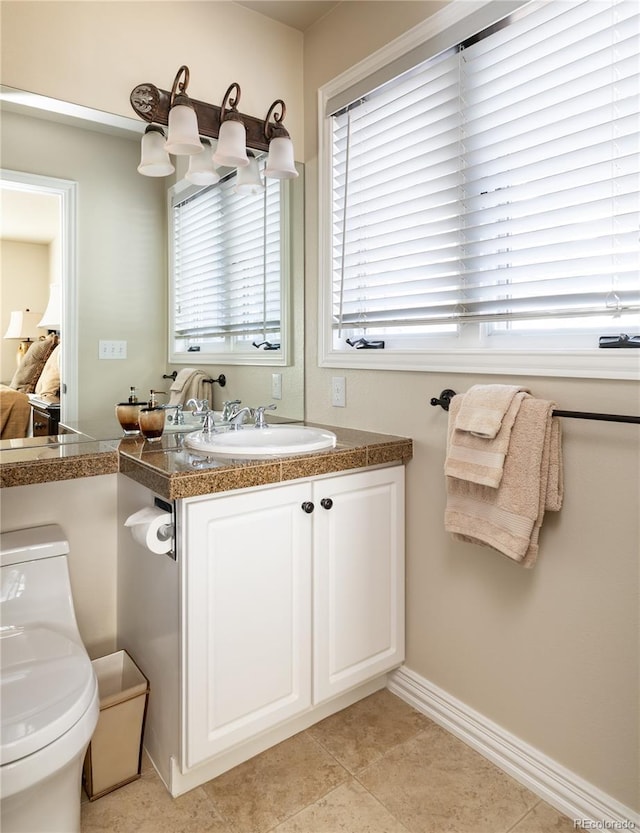 4483 W Cottonwood Pl, Littleton, CO 80123 - bathroom with vanity, baseboards, and toilet