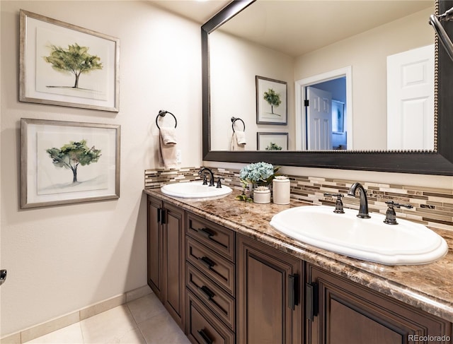 4483 W Cottonwood Pl, Littleton, CO 80123 - bathroom featuring backsplash, baseboards, double vanity, and tile patterned flooring