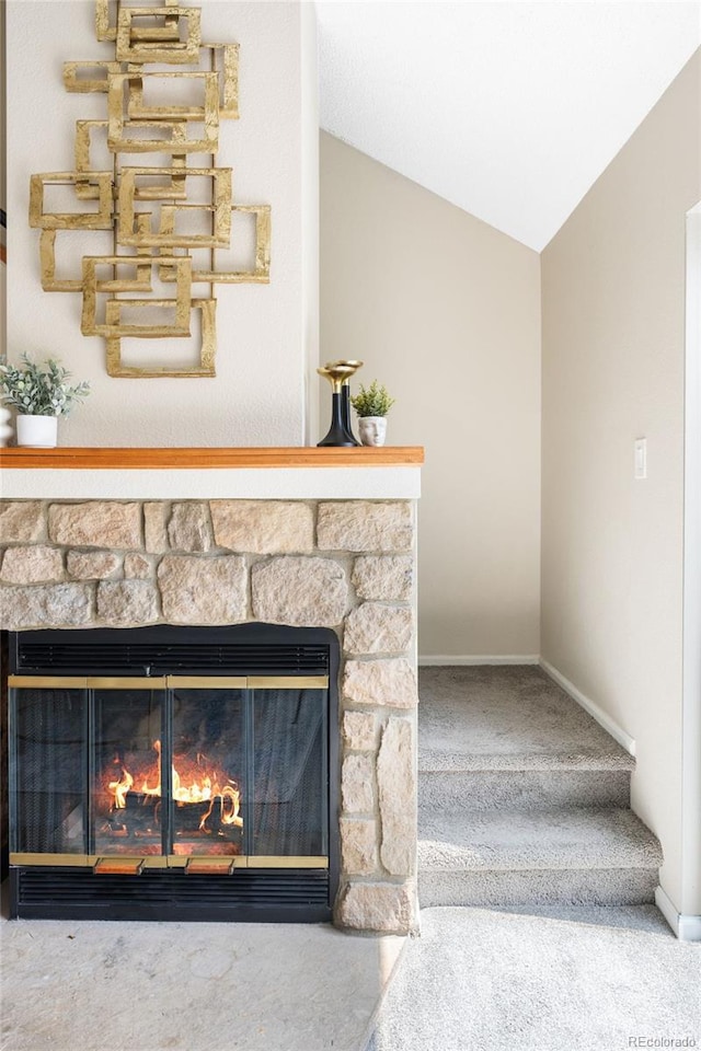 detailed view of a fireplace, carpet floors, and baseboards