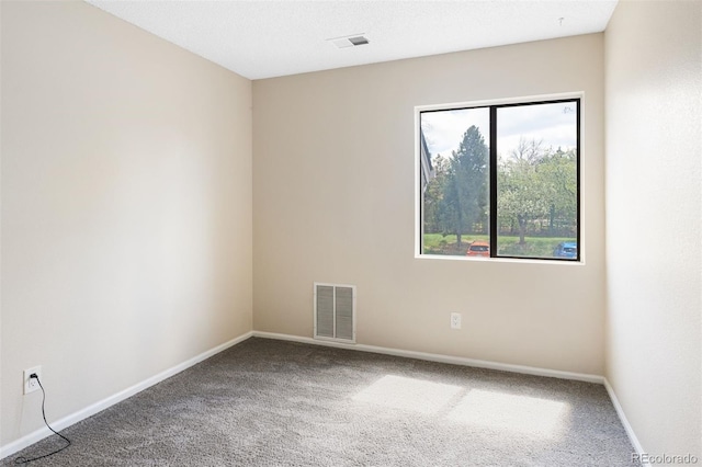 carpeted empty room with baseboards