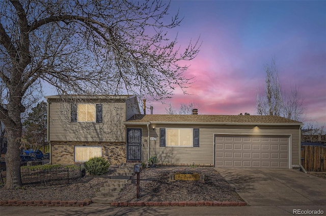 4063 S Quintero Way, Aurora, CO 80013 - split level home featuring fence, an attached garage, concrete driveway, a chimney, and brick siding