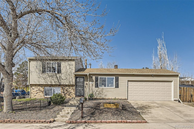 4063 S Quintero Way, Aurora, CO 80013 - split level home with fence, a garage, driveway, and brick siding