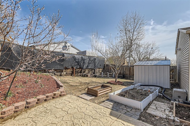 4063 S Quintero Way, Aurora, CO 80013 - fenced backyard with a vegetable garden, a storage shed, and an outbuilding