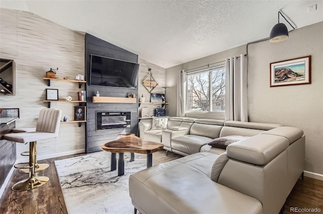 4063 S Quintero Way, Aurora, CO 80013 - living room featuring lofted ceiling, a textured ceiling, a fireplace, baseboards, and a textured wall