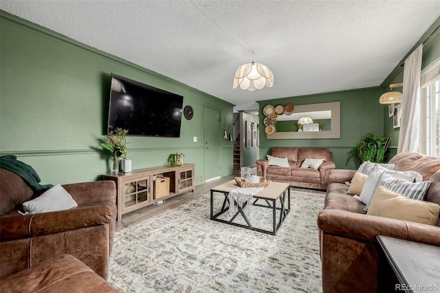 16051 E Alabama Dr, Aurora, CO 80017 - living room with ornamental molding, a textured ceiling, a chandelier, and wood finished floors
