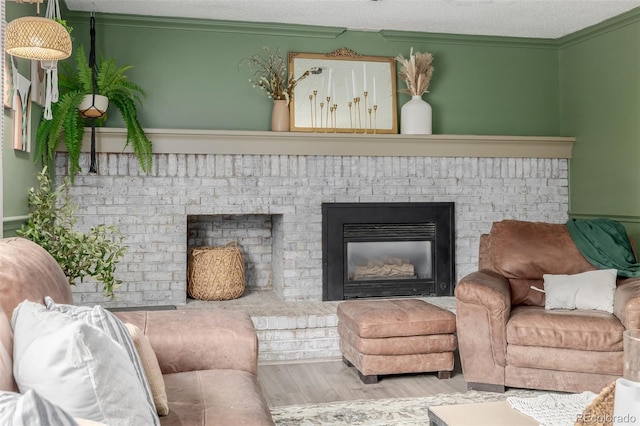 16051 E Alabama Dr, Aurora, CO 80017 - living room featuring a fireplace, ornamental molding, wood finished floors, and a textured ceiling
