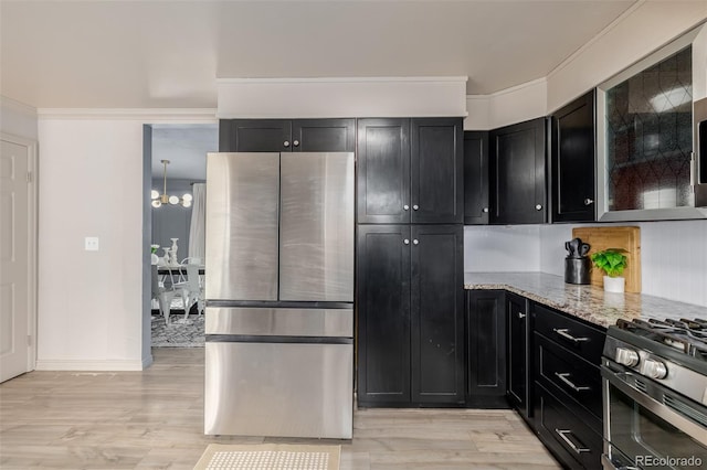 16051 E Alabama Dr, Aurora, CO 80017 - kitchen featuring appliances with stainless steel finishes, dark cabinetry, light stone countertops, light wood finished floors, and ornamental molding