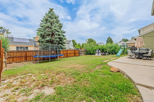 16051 E Alabama Dr, Aurora, CO 80017 - fenced backyard with a trampoline, a playground, and a patio