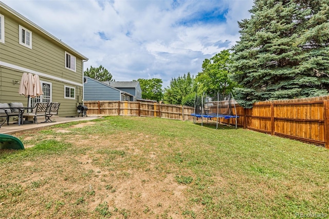 16051 E Alabama Dr, Aurora, CO 80017 - fenced backyard with a trampoline and a patio