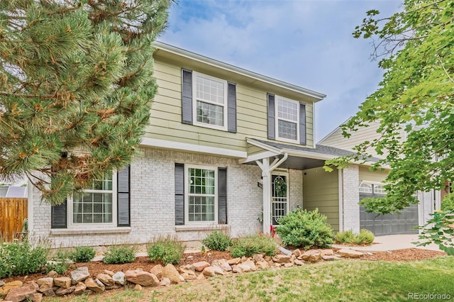 16051 E Alabama Dr, Aurora, CO 80017 - view of front of property with brick siding and a garage