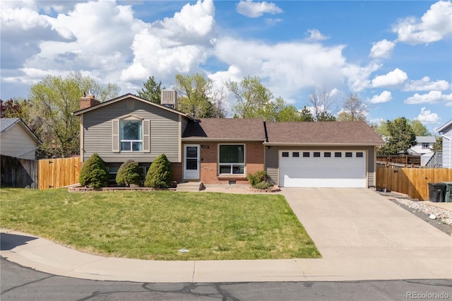 view of front of property featuring driveway, brick siding, an attached garage, and fence
