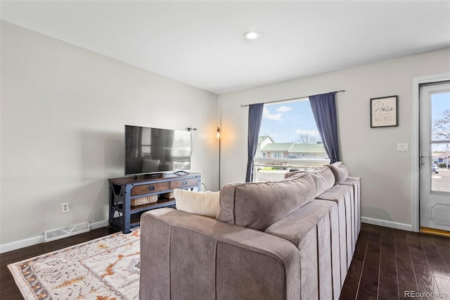 living room with visible vents, dark wood-style flooring, and baseboards