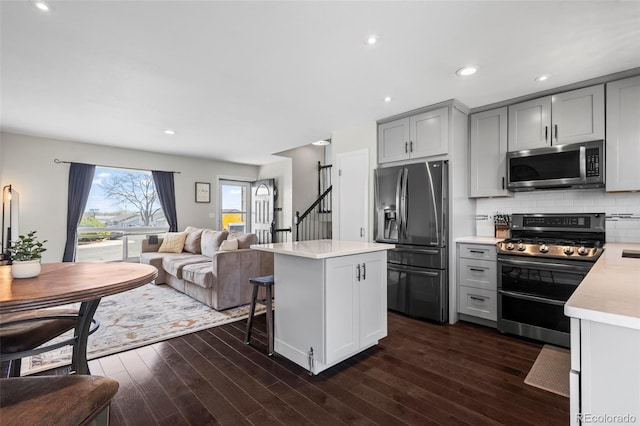 kitchen featuring dark wood finished floors, light countertops, appliances with stainless steel finishes, and gray cabinets