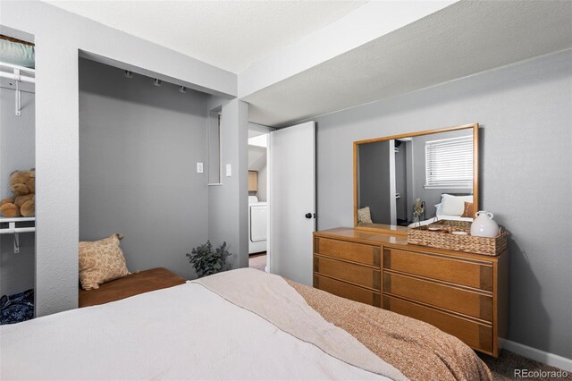 bedroom with carpet and washer / dryer