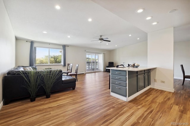 living room featuring light wood-type flooring and ceiling fan