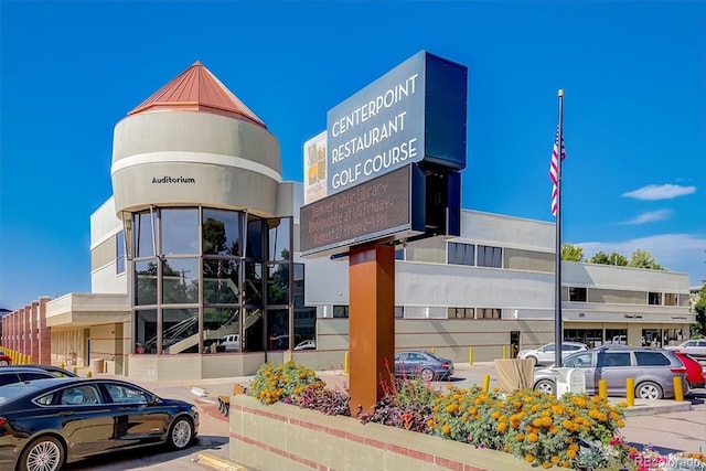 view of building exterior featuring uncovered parking