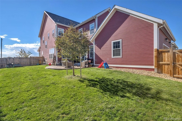 6288 N Dallas St, Denver, CO 80238 - back of property with a patio area and a fenced backyard