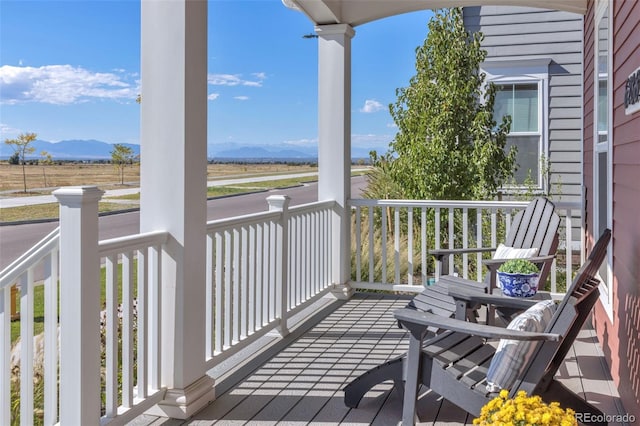 6288 N Dallas St, Denver, CO 80238 - wooden porch featuring a mountain view and a view of rural / pastoral area
