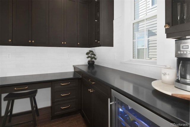 6288 N Dallas St, Denver, CO 80238 - kitchen featuring backsplash, dark countertops, beverage cooler, and dark wood-type flooring
